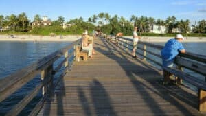 Gulf Coast beach with calm turquoise water and pier at Anna Maria Island Florida