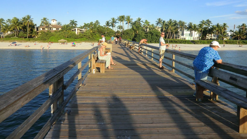 Gulf Coast beach with calm turquoise water and pier at Anna Maria Island Florida